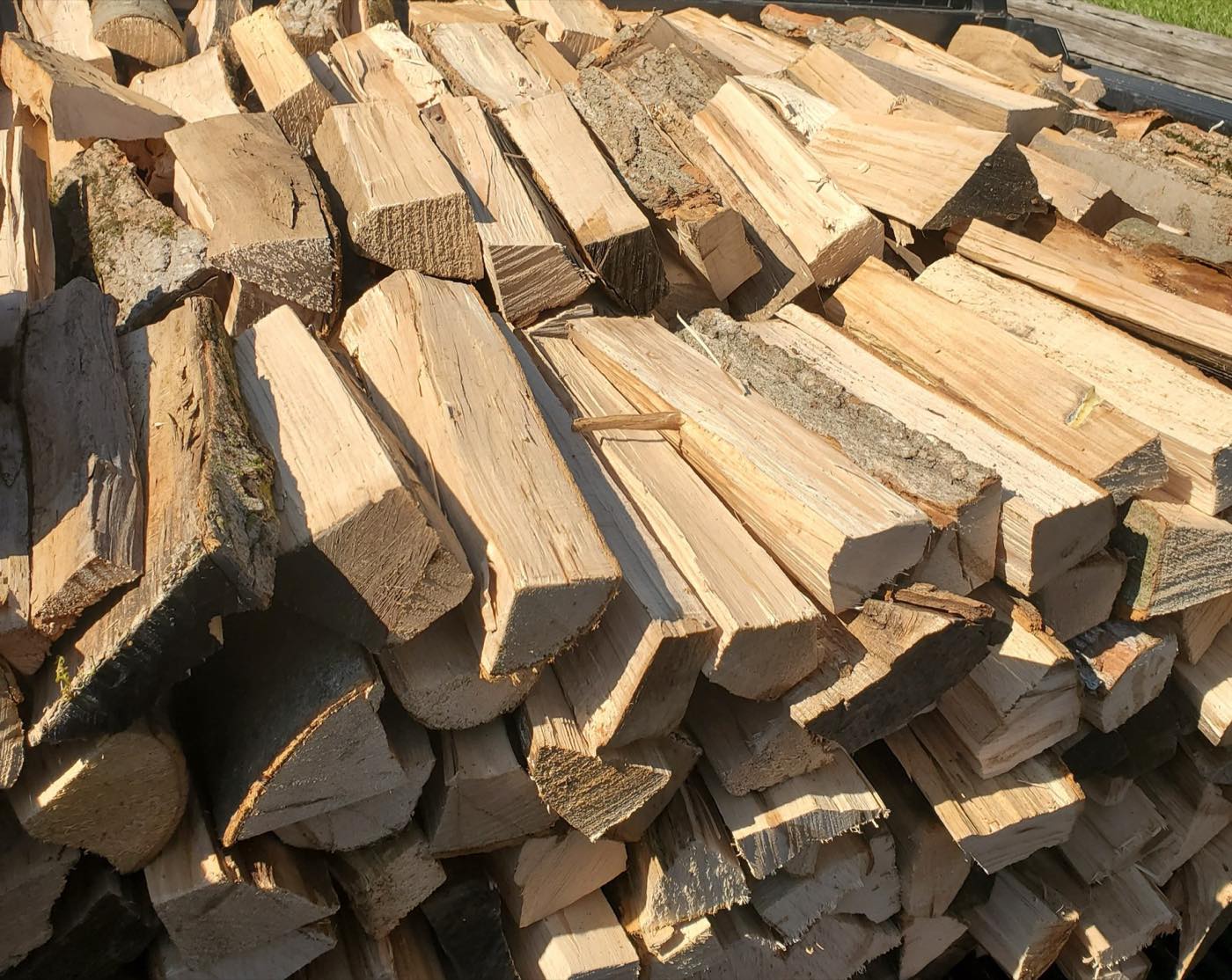 Freshly split hardwood stacked in a large pile